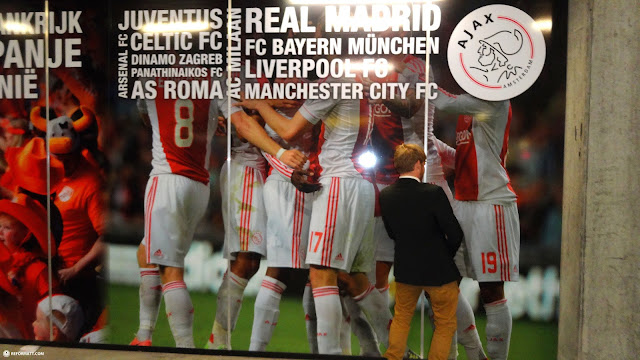 taking a piss on his favorite soccer club in Amsterdam, Netherlands 