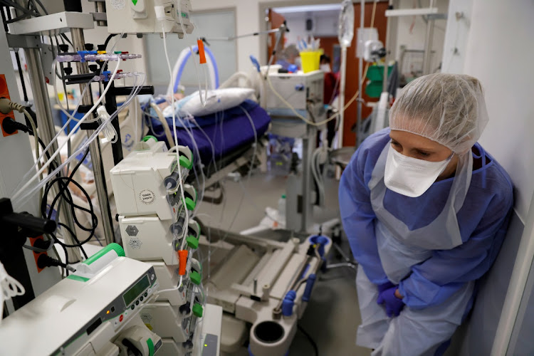 A medical worker, wearing protective gear, works in the Intensive Care Unit (ICU) where patients suffering from the coronavirus disease (Covid-19) are treated at Cambrai hospital, France, April 1, 2021.