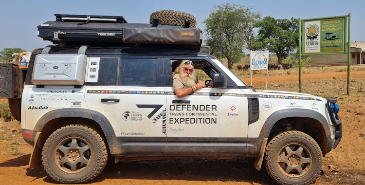 Kingsley Holgate behind the wheel of the new Land Rover Defender at the Uganda/South Sedan border.