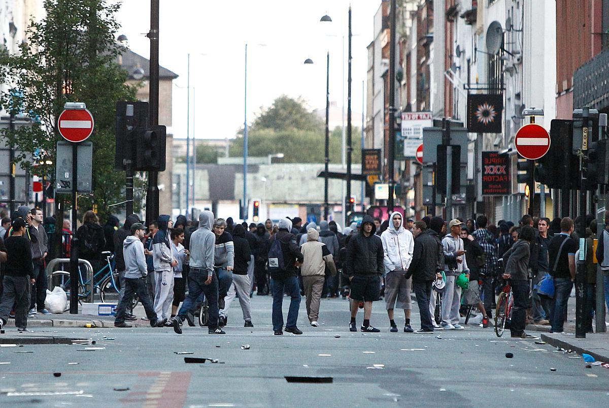 Crowds stand on Oldham street