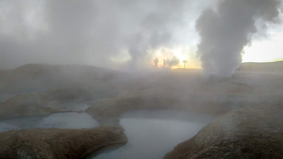 morning geysers in reflective salt flats in bolivia.jpg