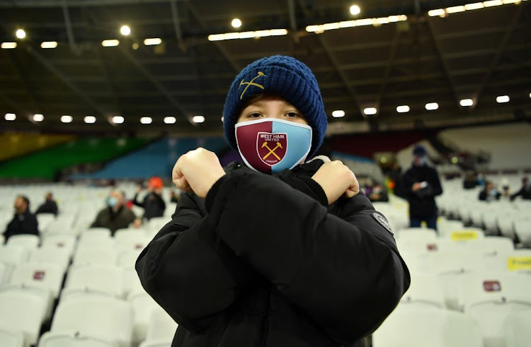 A West Ham United fan wearing a face mask inside the London Stadium on December 5 2020 before the Premier League match against Manchester United, as a limited number of fans are allowed to attend stadiums again after the Covid-19 outbreak.