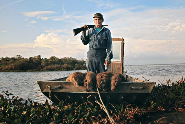 Nutria hunter Thomas Gonzalez appears with four dead nutria in the documentary “Rodents of an Unusual Size.” Photo: Tilapia Film