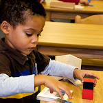 Preschool boy in Huntington Beach Montessori school working with mathematics material.