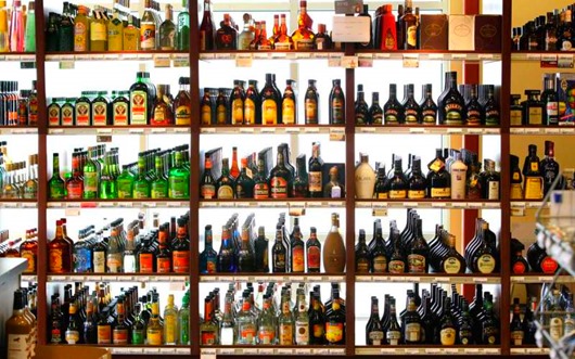 Bottles of liquor are shown on shelves at a state-run liquor store, Wednesday, March 7, 2012, in Seattle. Washington state begins the process of fully privatizing its alcoholic beverage business on Thursday when a public auction of state-run liquor stores opens online, marking a historic change for a state that has tightly controlled its booze since the end of Prohibition. (AP Photo/Ted S. Warren)