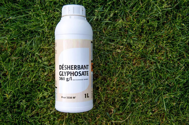 A bottle of glyphosate, a controversial chemical found in herbicides, lies on grass. Photo: AFP