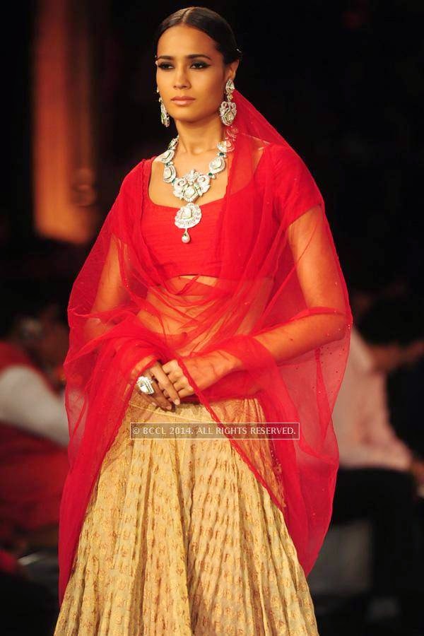 A model walks the ramp for Shree Raj Mahal Jewellers on Day 6 of India Couture Week, 2014, held at Taj Palace hotel, New Delhi.<br /> <br /> <br /> 