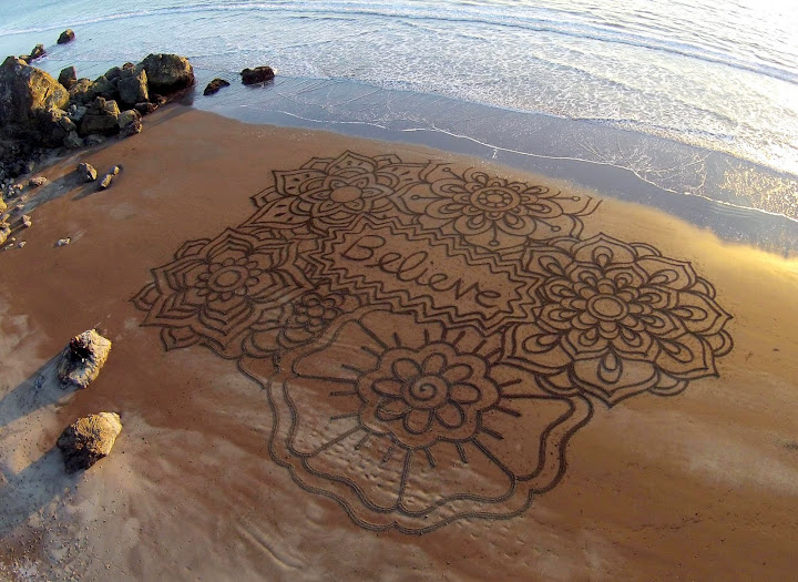 Believe. The sand sign project.  By Andres Amador, a sand artist of world recognition