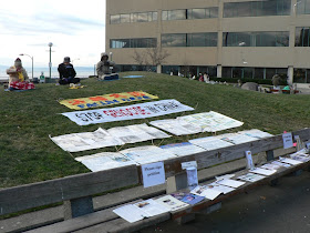 banners on hillside saying Falun Dafa Stop Genocide in China