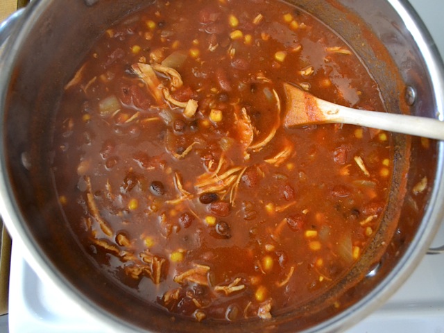 shredded chicken added to pot of chili 