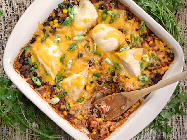 Top view of Salsa Chicken Casserole  with wooden spoon scooping some out 