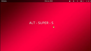 descrição da imagen, tela inicial do gnome, papel de parede vermelho com a frase alt + super + s no centro, fim da descrição