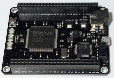 The Mojo FPGA board. The Spartan-6 FPGA chip dominates the board.