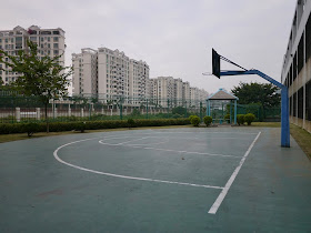 A partial basketball court in Macau in sight of apartments in Zhuhai