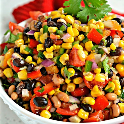 Tasty Cowboy Caviar made with beans, black eyed peas, and fresh vegetables all in a spicy lime vinaigrette.  Serve as a dip, or spoon over grilled fish, grilled chicken, omelettes, tacos, burritos and enchiladas.