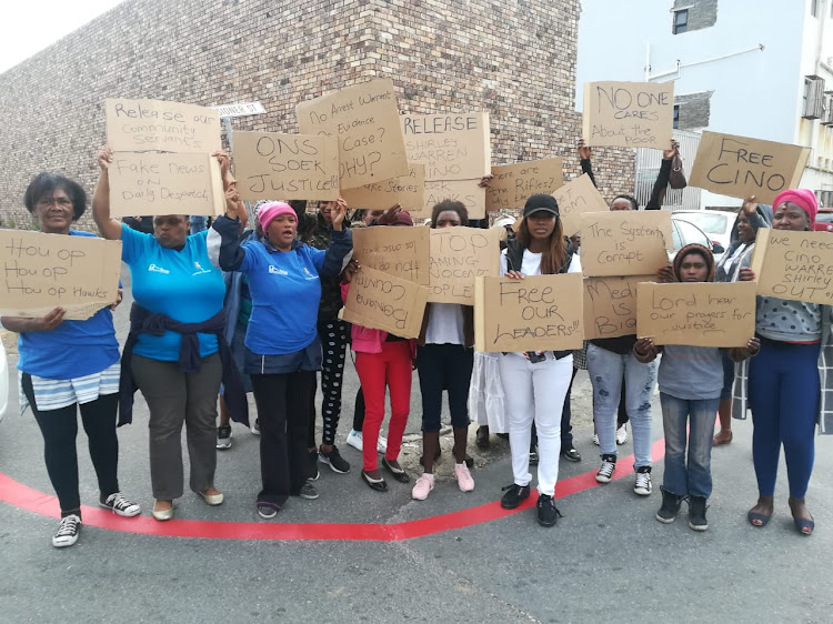 A group f women stand outside the East London Magistrate's court in support of humanitarian Cino Shearer