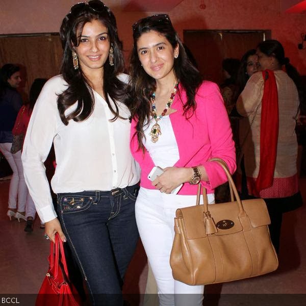 Raveena Tandon poses with a friend during Anu Ranjan's b'day party, held in Mumbai, on October 9, 2013.