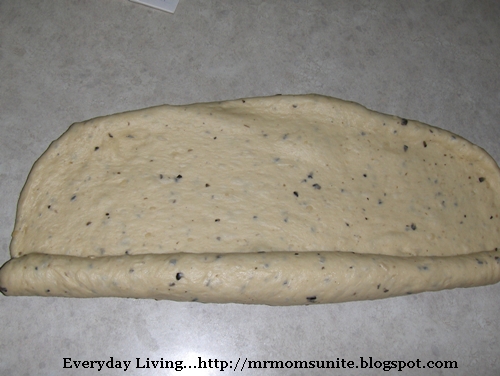 photo of the dough being rolled into a log