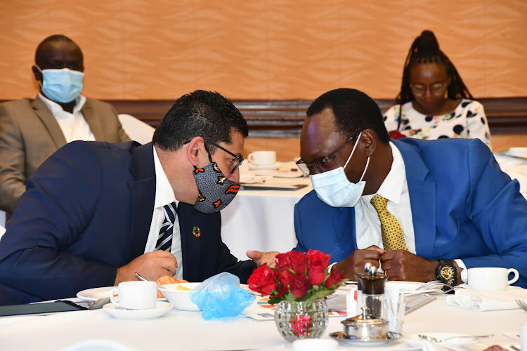 Environment PS Dr. Chris Kiptoo shares a word with UNDP Resident Representative Walid Badawi November 18 at Serena Hotel. Image: Gilbert Koech.