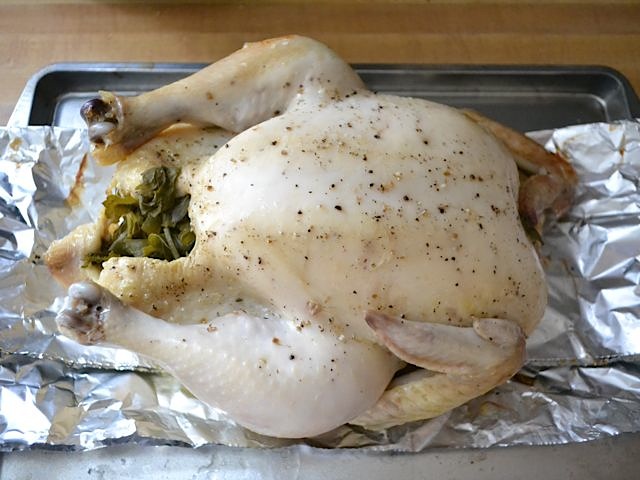 cooked chicken taken out of slow cooker and placed on baking sheet