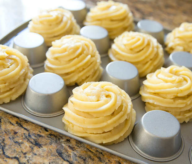 photo of the churro dough piped around upside-down muffin cups