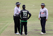 Umpires chat to Dolphins captain Khaya Zondo over Omphile Ramela's injury during the Momentum One Day Cup match between Hollywoodbets Dolphins and BuildNat Cape Cobras at Pietermaritzburg Oval on February 26, 2017 in Pietermaritzburg, South Africa.