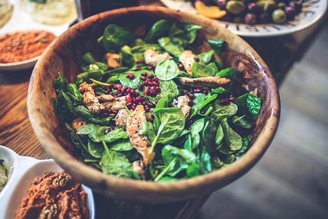 A bowl of spinach salad