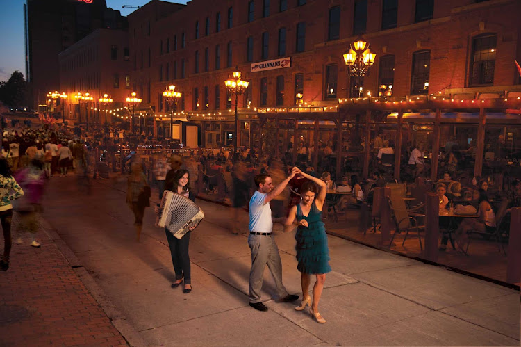 Music and dining go hand in hand as evening descends on a row of restaurants on the Saint John Boardwalk. 