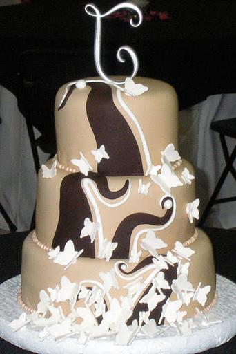 Three tier round taupe fondant custom wedding cake with brown swirls and