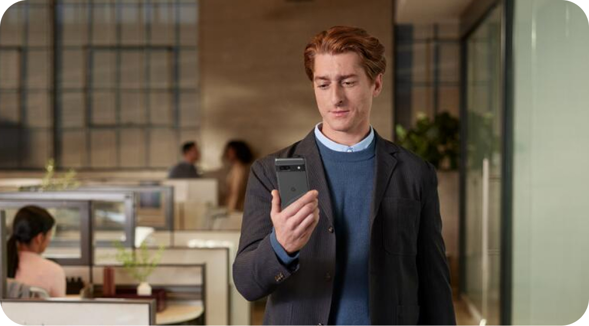 Man in office working on his Pixel phone.