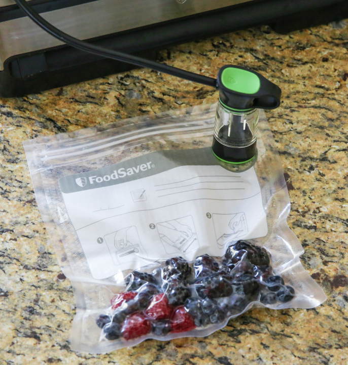 photo of fruit being sealed into a bag