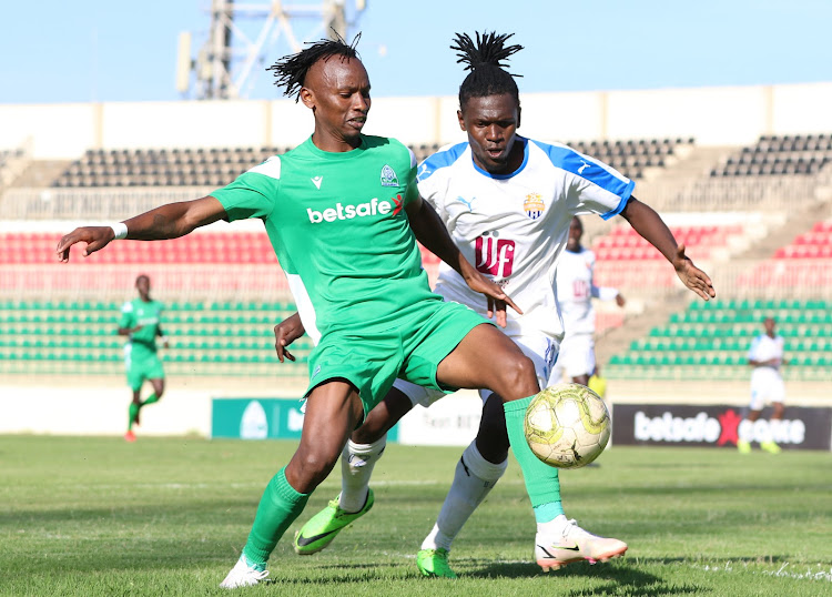 Gor Mahia's John Macharia (L) shields the ball from Edwin Buliba of City Stars during their Premier League clash at Nyayo Stadium.