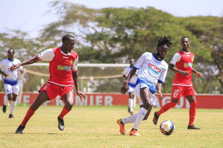 Posta Rangers' forward Caleb Olilo vies for the ball against Marvin Nabwire of Kenya Police during their Kenyan Premier League match at Moi Stadium, Kasarani.