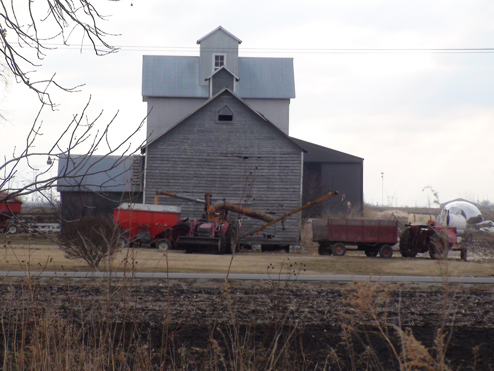 Will County Farming Shelling Ear Corn from a Corn Crib