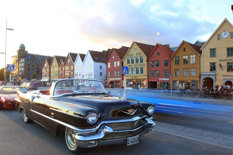 Norwegian summers bring outdoor dining and classic cars to Bryggen, near Bergen, Norway.