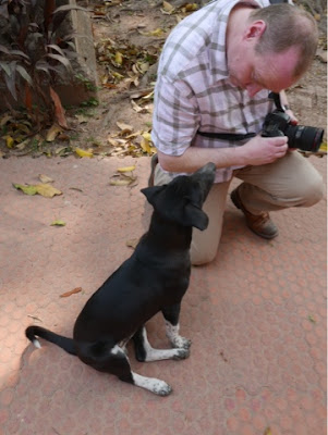 A man with a small black dog