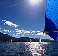 J/24s sailing into the sun off Arzachena, Sardinia (near Porto Cervo)