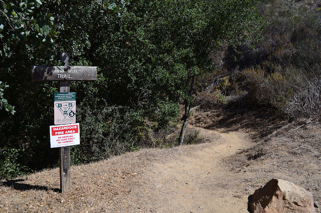 small sign next to a well trod path