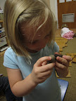 A child examines rocks up close.