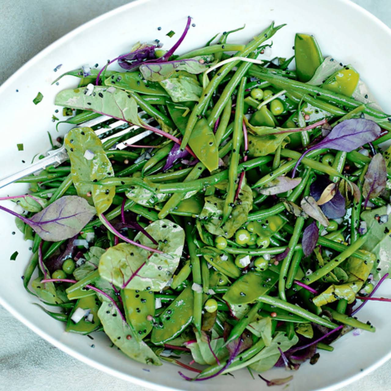 Sugar snap pea salad with shaved onion, radish, basil, and mint