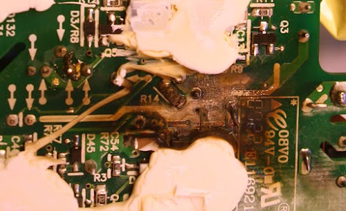 Burn mark inside an 85W Apple Macbook power supply that failed.