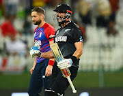 Daryl Mitchell of New Zealand celebrates victory as Chris Woakes of England looks on in the ICC Men's T20 World Cup semifinal at Sheikh Zayed stadium  in Abu Dhabi, United Arab Emirates on November 10 2021.