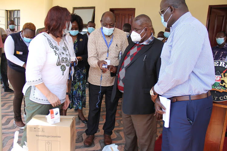 Homa Bay Health executive Richard Muga uses pulse oxymeter to check the oxygen of Governor Cyprian Awiti on August 11, 2021.