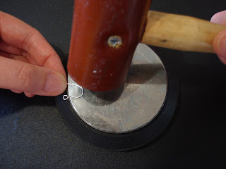 Tap the earwire with a mallet or hammer