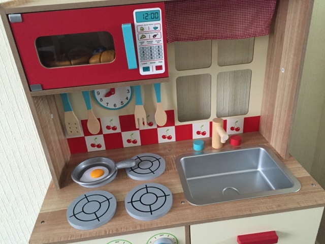 A microwave oven sitting on top of a wooden table