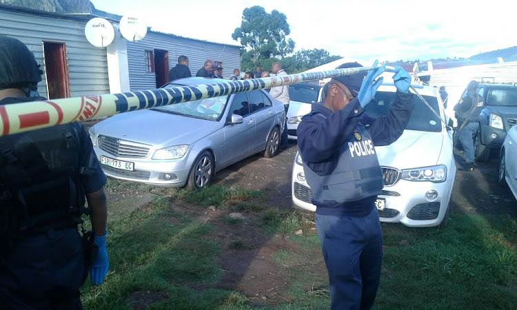 Police secure the area after the shootout on Friday.