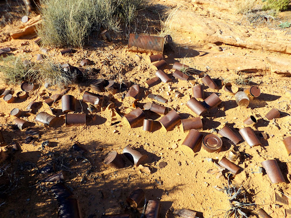 Cans and bottles near a drill hole