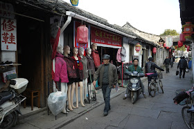 man walking by mannequins at Xiaoshan Street in Shaoxing, China 