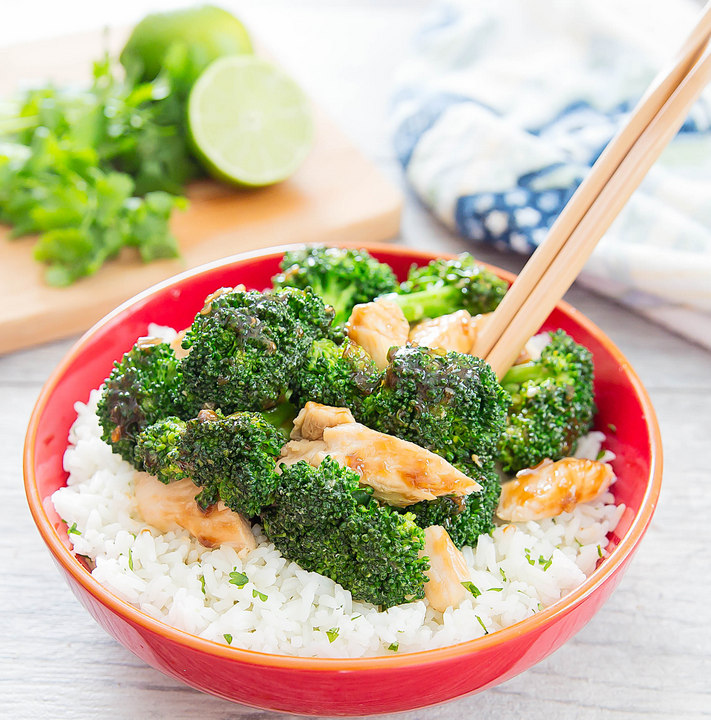 photo of a bowl of Garlic Chicken and Broccoli Stir Fry with Cilantro Lime Rice with chopsticks