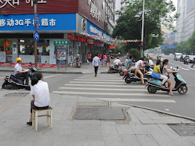 woman sitting on a stool in Hengyang, Hunan, China